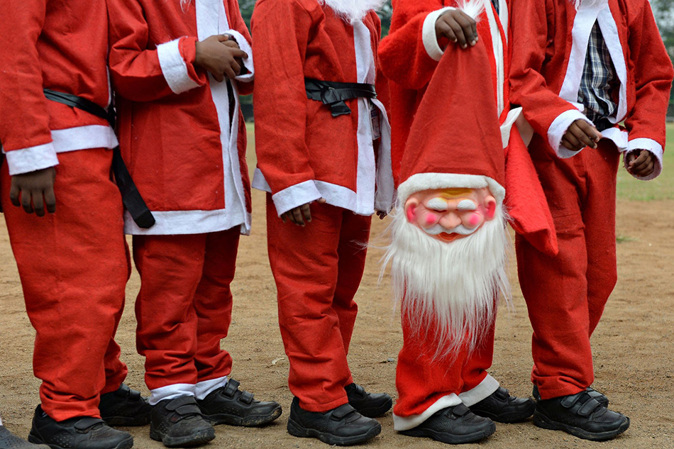 06VCG111180232402Indian schoolchildren dressed as Santa Claus pose as they take part in a Christmas event at a school in Chennai on December 5, 2018.