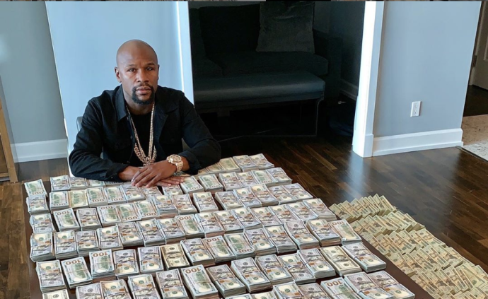 美国拳王摆百万美元现钞炫富只是墙纸
