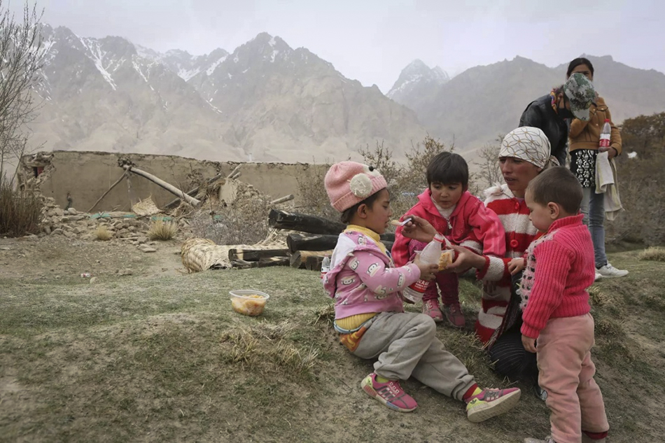 5月11日，在新疆塔什库尔干县库孜滚村，受灾村民在空旷地带吃抓饭。