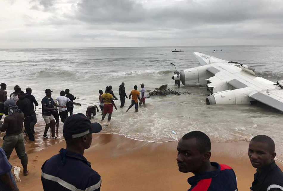 People pull the wreckage of a propeller-engine cargo plane after it crashed in the sea near the international airport in Ivory Coast's main city, Abidjan, October 14, 2017.  (2)