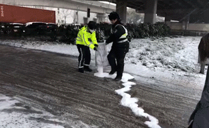 大雪袭沪，交警全员上岗撒盐除雪融冰